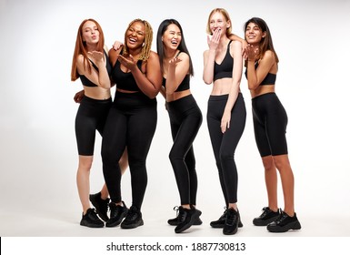 women blowing kiss on camera, have fun together, friendship between ladies of different nationalities and body size, isolated white background