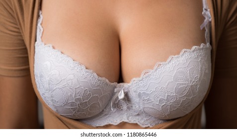 Women body. Bra model. Plastic surgery. Female breast. Women body shape. Breast boobs, woman after plastic surgery. Close up of breast of attractive girl presenting her bra. Woman in underwear.