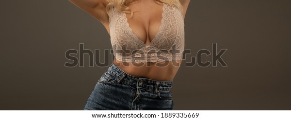 Women body. Bra model. Plastic surgery. Female\
breast. Women body shape. Breast boobs, woman after plastic\
surgery. Close up of breast of attractive girl presenting her bra.\
Woman in underwear.