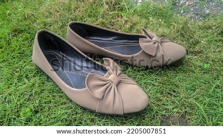 Women brown shoes on the green grass