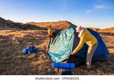 Women Building A Tent In The Mountains, Preparing For A Camping Night.	