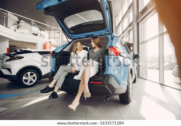 Women buying the\
car. Ladies in a car\
salon