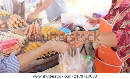 Women are buying food in the market.