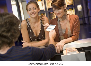 Women Buying Movie Tickets At The Box Office.