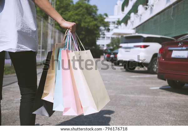 Women carry a lot of shopping bags. In the mall\
And walking back to the car\
park.