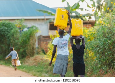 Women Carrying Water Cans In Uganda, Africa