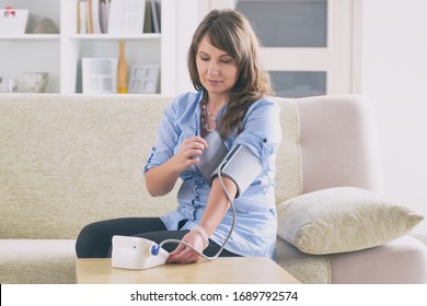 Women Checking Blood Pressure At Home