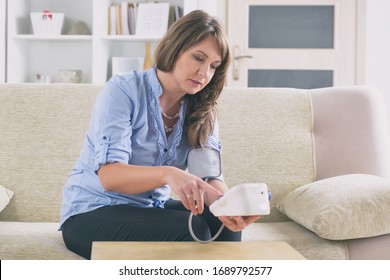 Women Checking Blood Pressure At Home