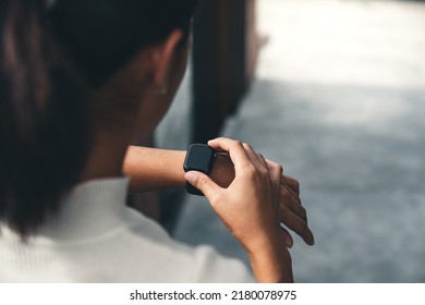 women checking on smart watch - Powered by Shutterstock