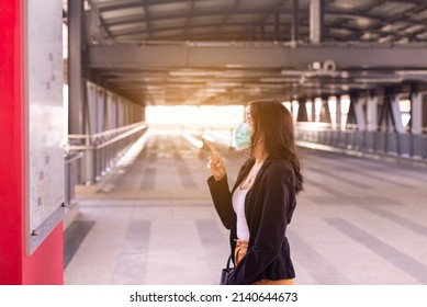 Women Checking Time Schedule At Train Station,Travel Insurance Concept