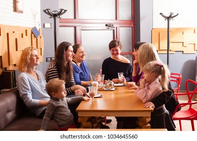 Women and children having a drink