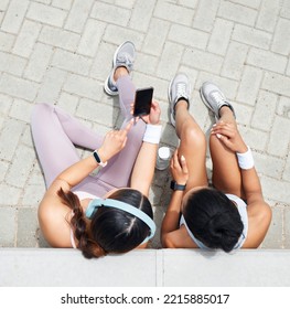 Women In City, Online Workout App In Miami And Healthy Friends Relax Sitting On Urban Floor Watching Fitness Video. Girl Streaming Audio Podcast, Show Social Media Exercise And Outdoor 5g Technology