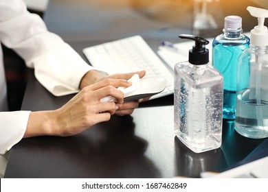 Women Cleaning A Computer Mouse With Alcohol Pad. Hygiene Sanitize Concept. Prevent The Spread Of Germs And Bacteria And Avoid Infections Corona Virus Or Covid 19.selective Focus               