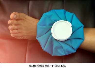 Women compress ice bag  to the ankle, relieving pain.on green background.