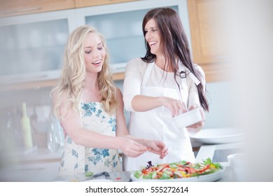 Women cooking together in kitchen - Shutterstock ID 555272614