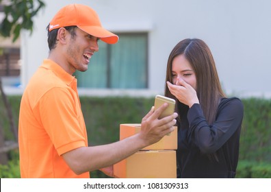 Women Cover Her Mouth With Happy Surprise On Delivery Package By Delivery Man, For Friendly Delivery And Local Logistic Business Concept.