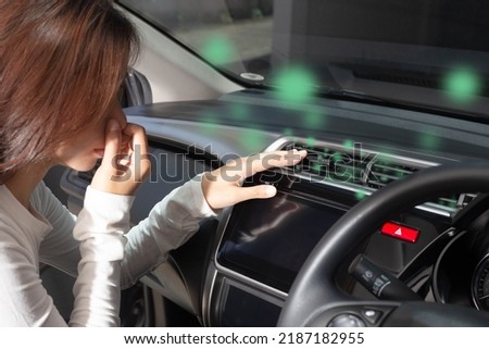 Women cover their noses from foul odors. Bad smell from the vent on the instrument panel when the air conditioner is on. concept of vehicle inspection