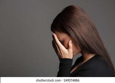 Women Crying. Side View Of Young Women Crying And Hiding Face In Hands While Isolated On Grey