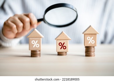 women customer using magnifying glass finding to interest rate home is minimum, affordable alternative price, mortgage home, financial and investment concept.  - Shutterstock ID 2218189005