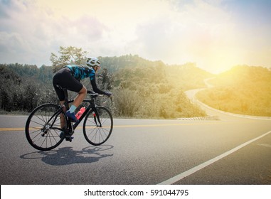 Women Cycling Mountain Road Bike In The Morning