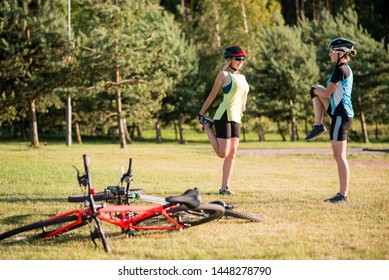 Women cyclist doing exercises after riding a bike outdoors in the park - Powered by Shutterstock