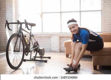 Women Cyclists Wearing Shoes Prepare To Bike At Home On The Trainer.