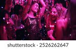 Women, dancing and glitter in night club for party, celebration and excited for New Year. Friends, movement and energy on dancefloor for event, disco or birthday social with neon lights for aesthetic