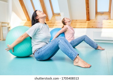 Women Do A Back Exercise Together With The Gym Ball In The Fitness Center