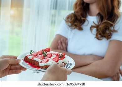 Women Do Not Eat Sweets And Desserts. Hands Sending A Plate Of Strawberry Bread, But The Woman Showed A Declining Intention To Lose Weight And Lose Weight. Diet Concept