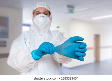 Women doctor wearing  protective suit to fight coronavirus pandemic covid-2019. Protective suit, googles, gloves, respirator. - Shutterstock ID 1683323434