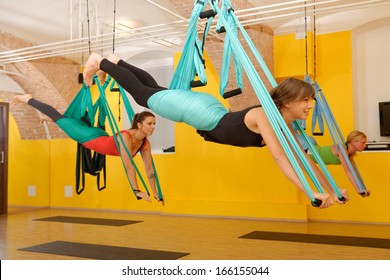  Women Doing Anti Gravity Aerial Yoga Exercise In The Gym