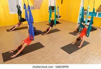 Women Doing Anti Gravity Aerial Yoga Exercise In The Gym  