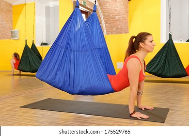 Women doing anti gravity Aerial yoga exercise in the gym  