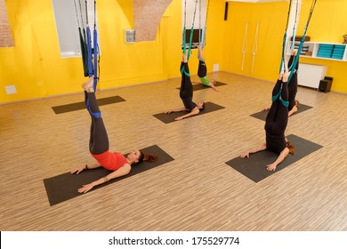 Women Doing Anti Gravity Aerial Yoga Exercise In The Gym 