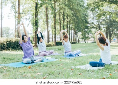 Women doing outdoor yoga, park yoga, forest bathing, and yoga classes - Powered by Shutterstock