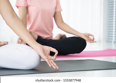 Women doing yoga exercise together, Concept of wellness, healthy life and healthy activity in every day lifestyle.  Photograph with copy space.