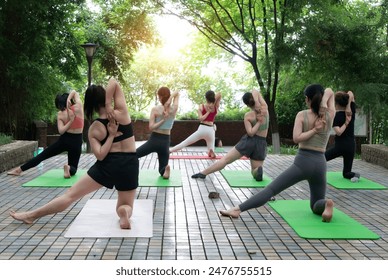 Women doing yoga in the park - Powered by Shutterstock