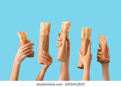 Women with doner kebabs on blue background