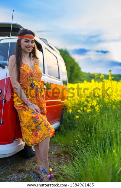 women dressed in boho style are\
standing by the hippie van - Bieszczady Poland\
10.12.2019