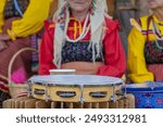 women dressed in traditional russian costume playing tambourines at a popular festival, folk music