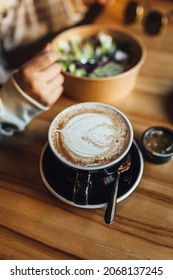 Women Drinking Chai Latte At Coffee Shop, Seasonal Coffee Drinks With Latter Art.