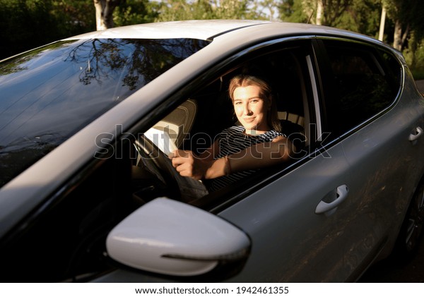 Women\
driving a car during the drive to travel\
journey.