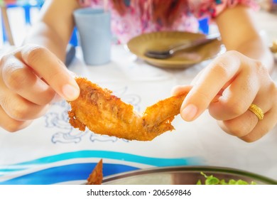 Women Eating Chicken Wings.Thai Food.