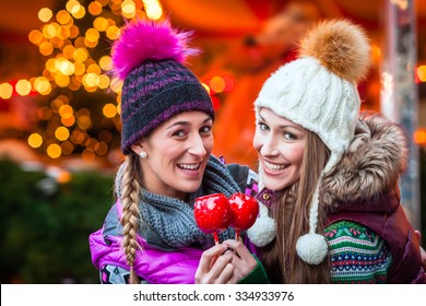 Women Eating Crystalized Apples On German Christmas Market