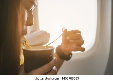 Women Eating Noodles On The Plane