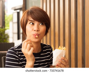 Women Enjoy Eating With Her French Fries,asian Girl Happy With Her French Fries,enjoy Eating,french Fries In White Bag