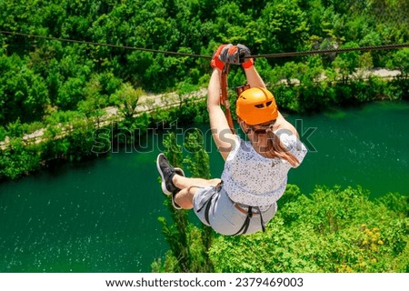 Women Enjoying a Thrilling Zipline Experience, Embracing the Exhilaration of Activity-filled Vacation and Stunning Tourism Views