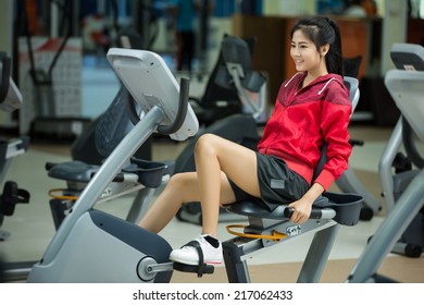 Women Exercise Bike In The Gym.