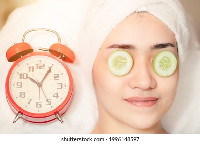 Women Facial Treatment In Spa With Time Clock. Beauty Times Reverse To Healthy Skin To Baby Face Anti Aging Cosmetic Concept.