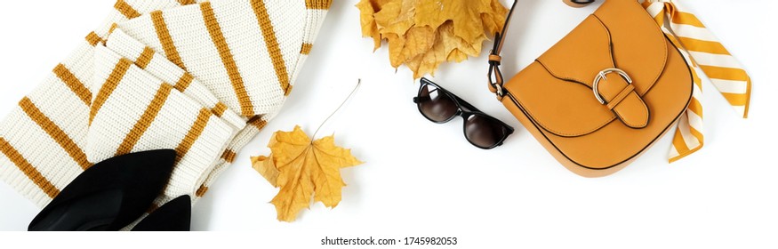 Women Fashion Clothes And Accessories Banner Top View On White Background. Flat Lay Collage Of Female Autumn Style Look With Wool Sweater, Shoes , Women's Pants, Bag, Sunglasses.Copy Space